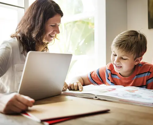 teacher and student learning with book and computer