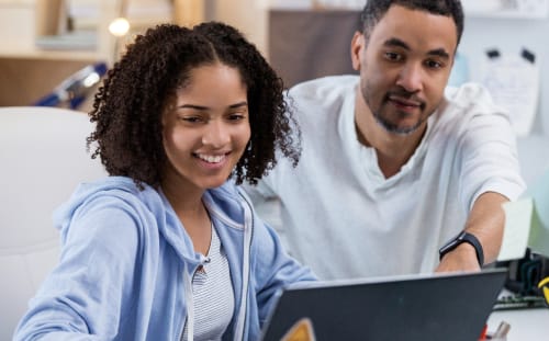 woman and man looking and using the computer